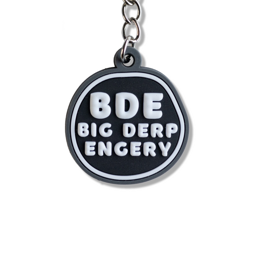 funny keychain: BDE Big Derp Energy Keychain - black, gray, and white irregular circle. Close up