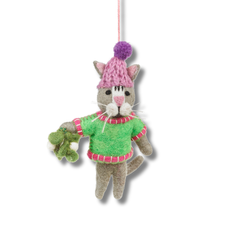 cute handmade felt cat ornament. cat is wearing a pink and lavender winter cat, a green sweater with red and white trim, and is holding felt mistletoe.