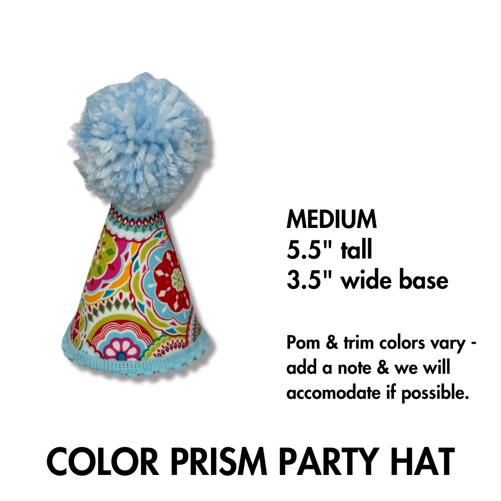 close up photo of our medium pet part hat in light blue pom and color prism of pink, orange with light blue trim