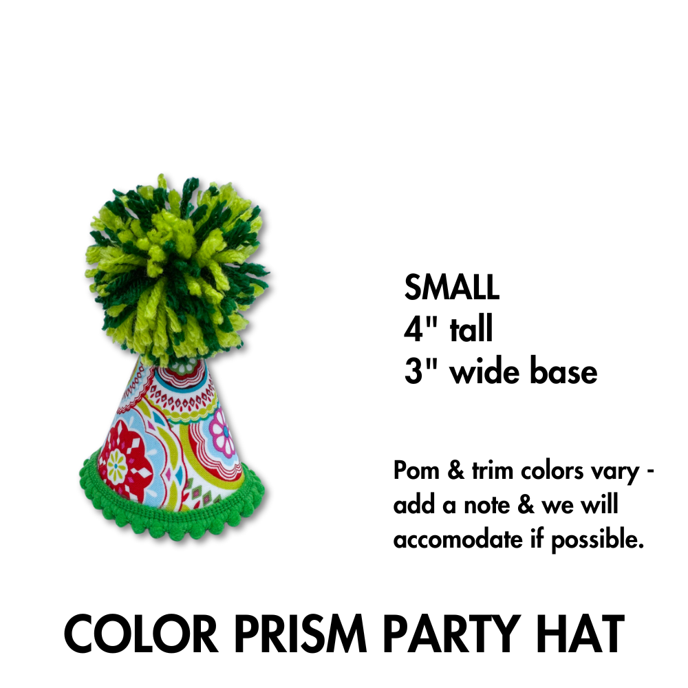 close up of our color prism pom pet party hat. This one has green pom and green trim. Fabric wrapped hat is colorful prism of dark pink, orange green, and light flue