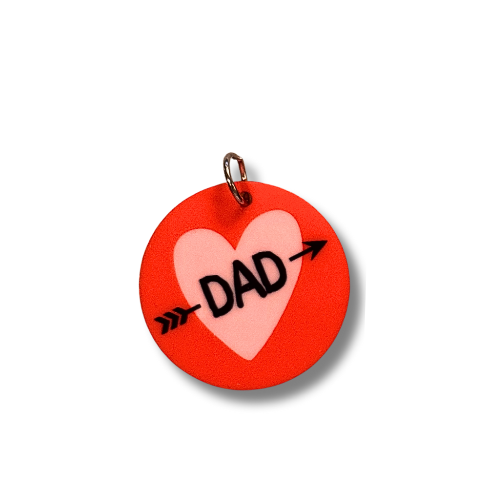 small et collar charm for Valentine's day dog... round dark pink/red circle with lavender heart and black text "DAD" with arrow through it.
