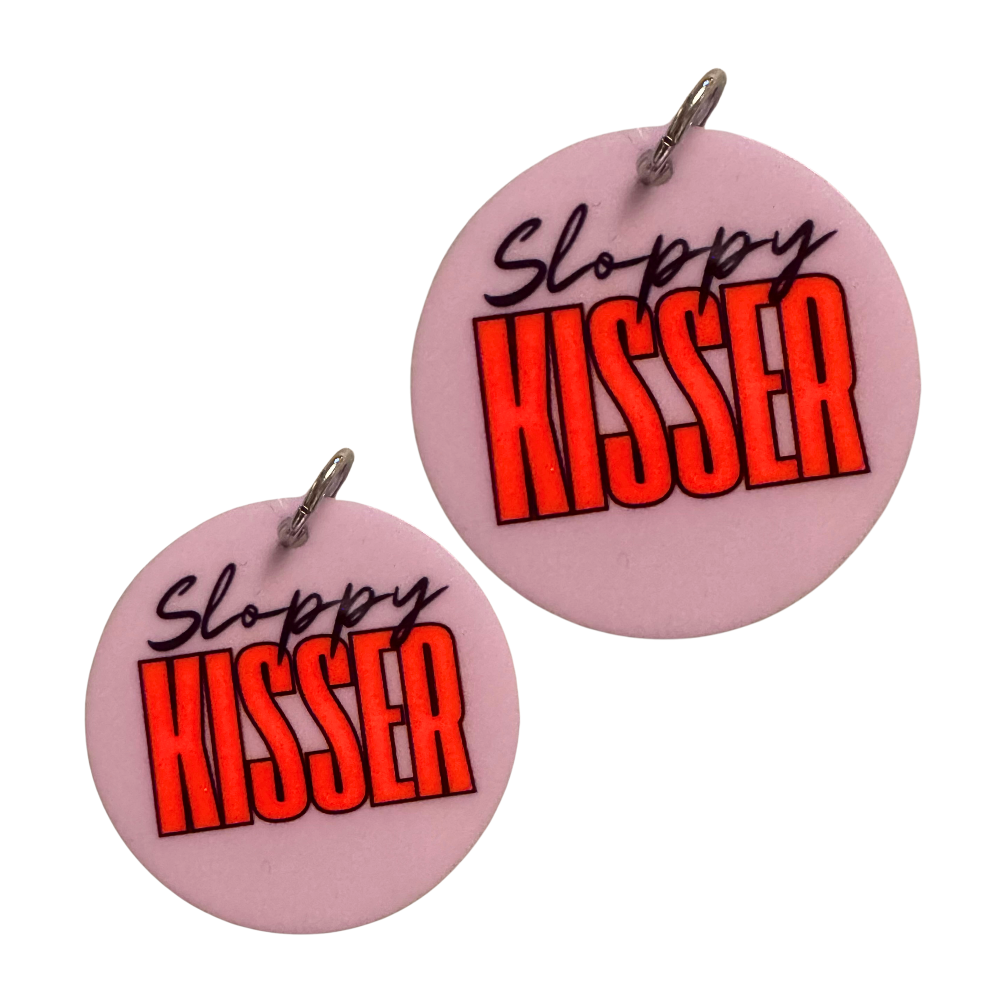 Cute dog accessory for valentines. Lavender circle with black script font "Sloppy" and tall modern font "Kisser." shown in two sizes for standard size breeds and large / XL breeds