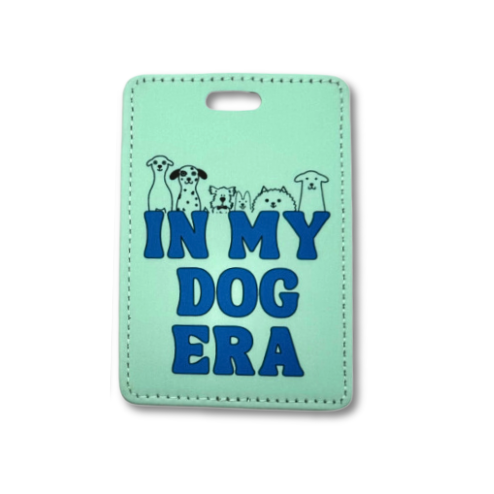 Pale green dog mom gift - suitcase tag "In my dog era" with 6 line art dogs poking out over the words.