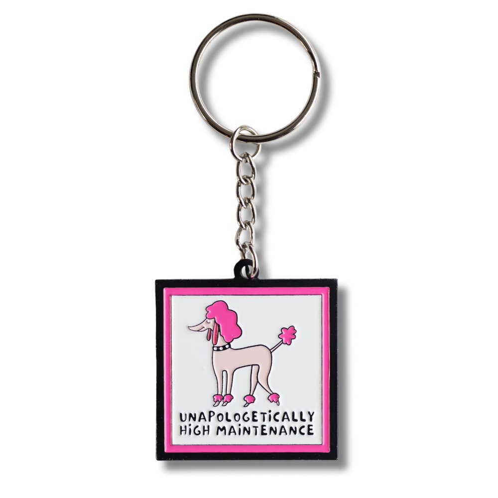 Full view of enamel keychain: Square with sassy pink poodle (light and dark pink) with words under: unapologetically high maintenance. Pink and black border.