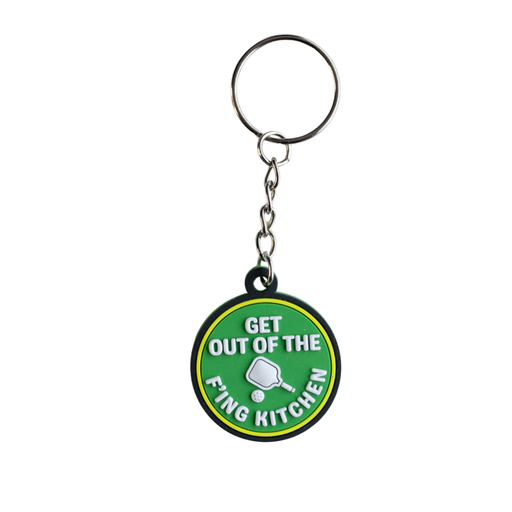 Funny Pickleball Keychain. Green with white raised letters and yellow and black border: Get out of the f'ing kitchen. Full view