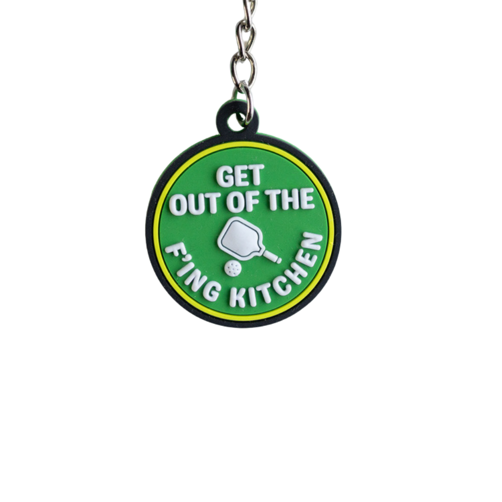 Funny Pickleball Keychain. Green with white raised letters and yellow and black border: Get out of the f'ing kitchen. Close up view.