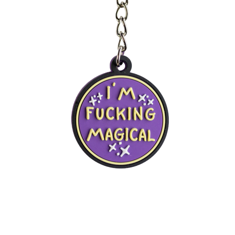 Funny purple keychain with raised yellow letters that says I'm F*cking Magical. Close up view