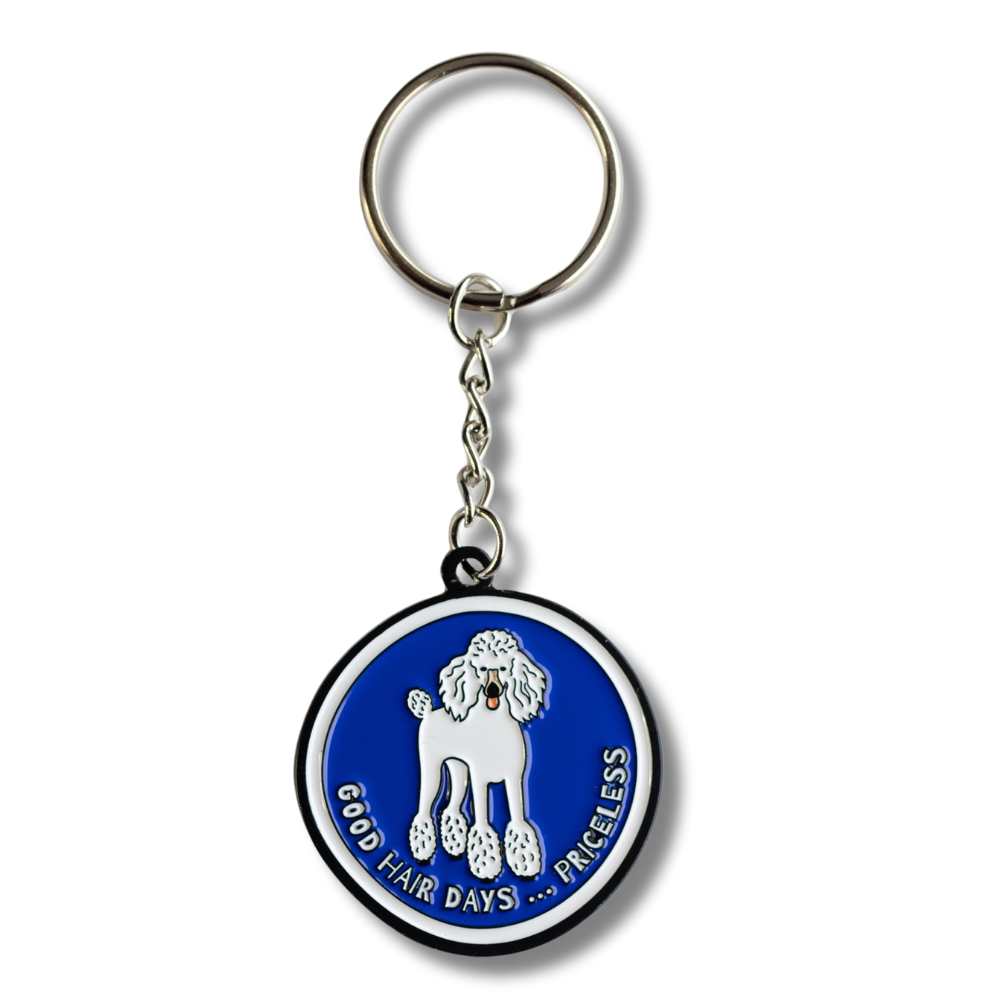 Blue round enamel poodle keychain with white poodle and white and black border. Text: good hair days ... priceless. Full view of keychain.
