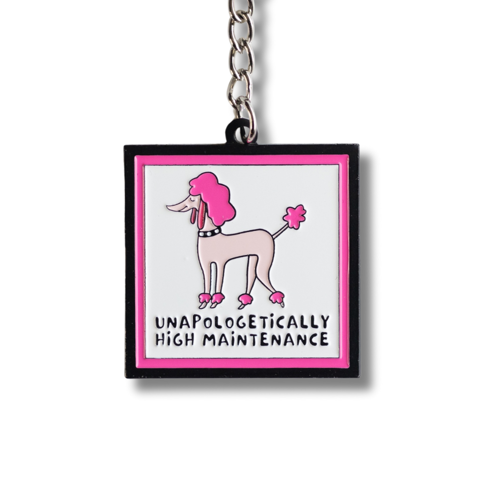 Close up of square enamel keychain with sassy pink poodle (light and dark pink) with words under: unapologetically high maintenance. Pink and black border.