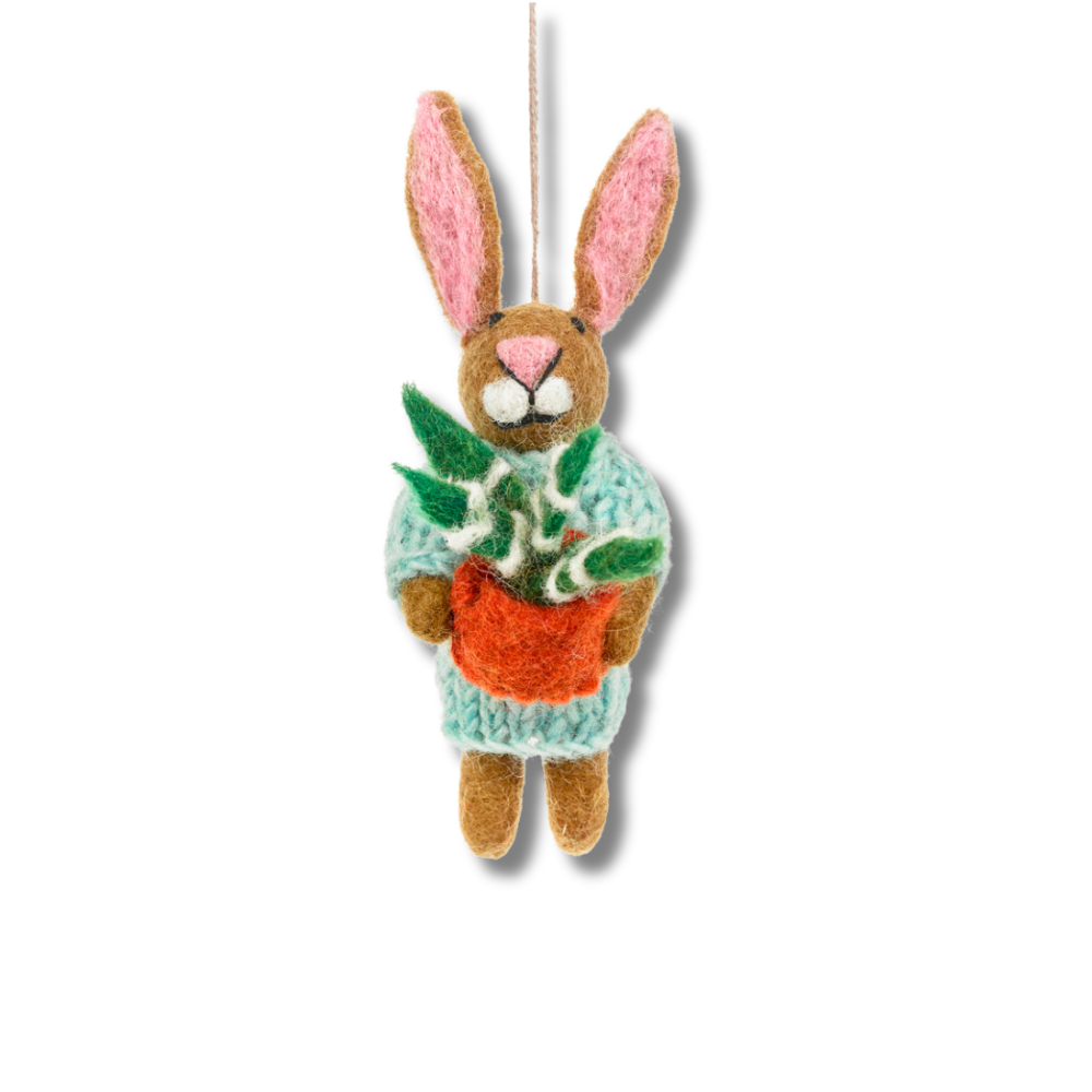 Front view of: cute bunny felt ornament. Brown rabbit is wearing a pale aqua hand-knitted sweated and holding a plant that has a rust orange pot and green and white leaves.