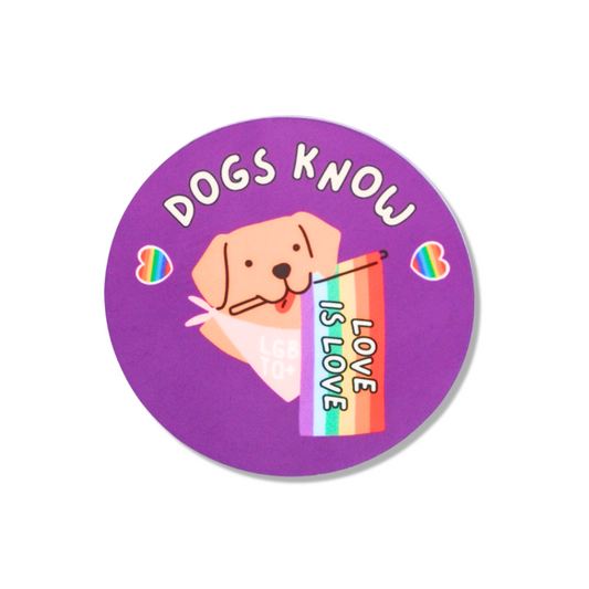 2.5" round pride pin. Purple with rainbow hearts. A dog holding a rainbow "love is love" flag.