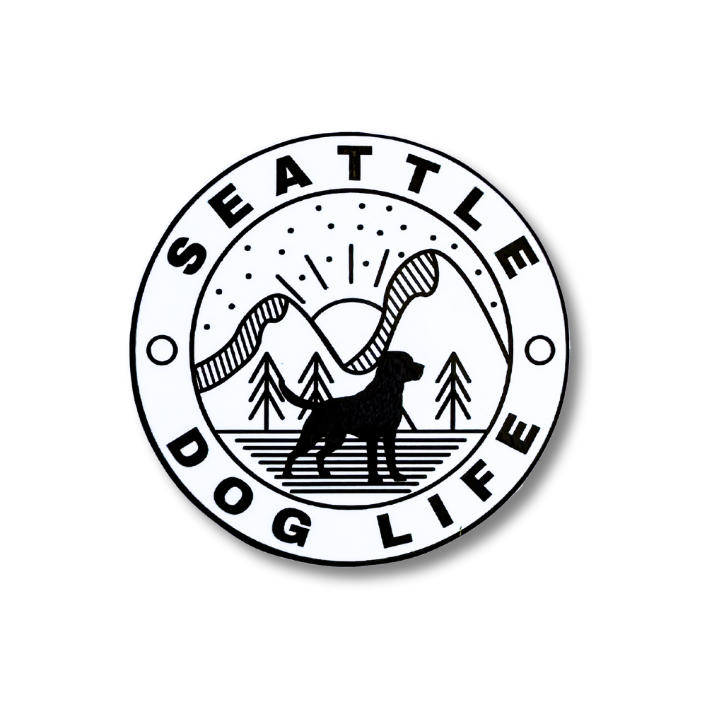 minimalist black and white sticker with line art mountain, sun, and trees with silhouette of dog in foreground: Seattle Dog Life