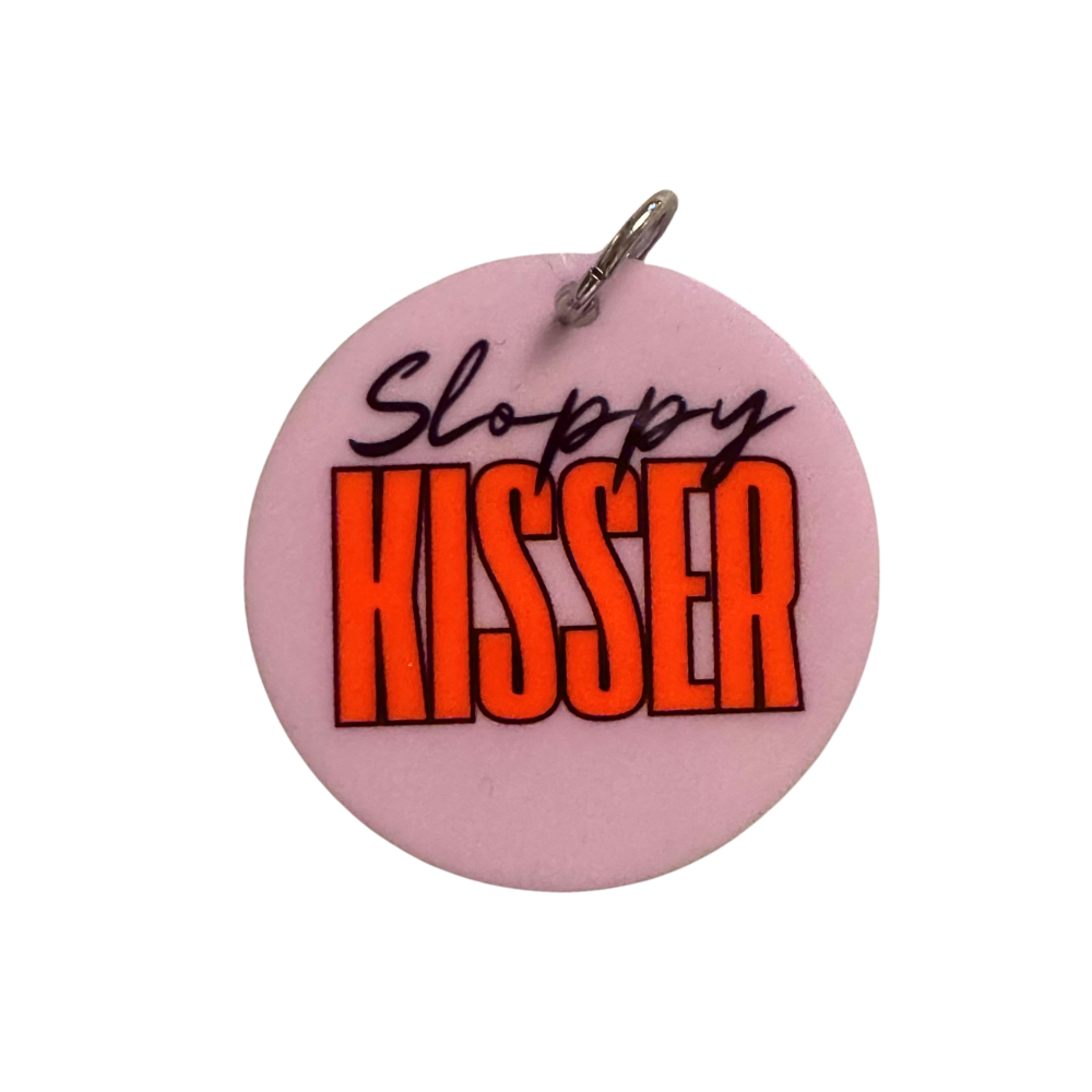 Cute dog accessory for valentines. Lavender circle with black script font "Sloppy" and tall modern font "Kisser." shown in larger size for large / XL breeds