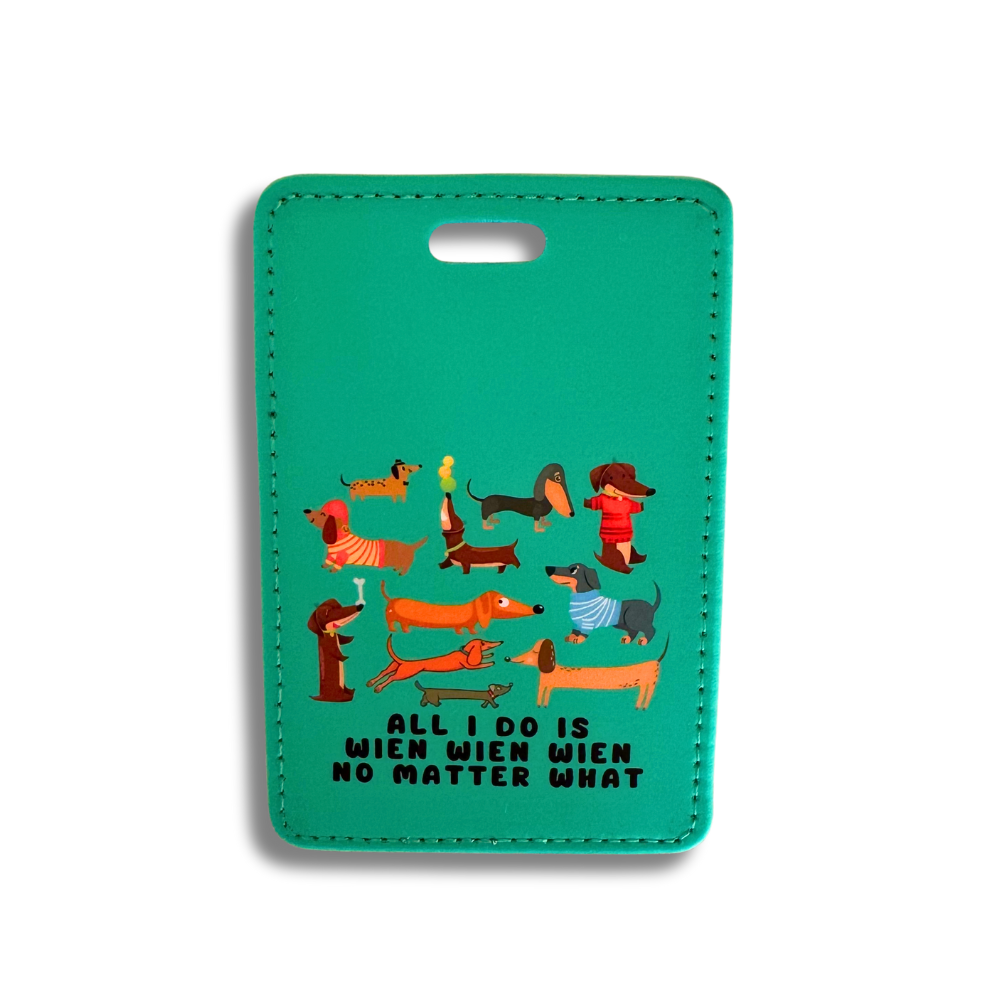 Green faux leather luggage with a large number of cute dachshunds on it and caption says All I do is wien wien no matter what.