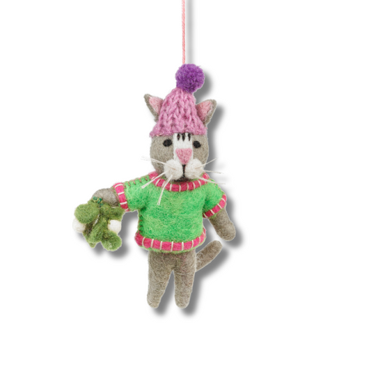 cute handmade felt cat ornament. cat is wearing a pink and lavender winter cat, a green sweater with red and white trim, and is holding felt mistletoe.