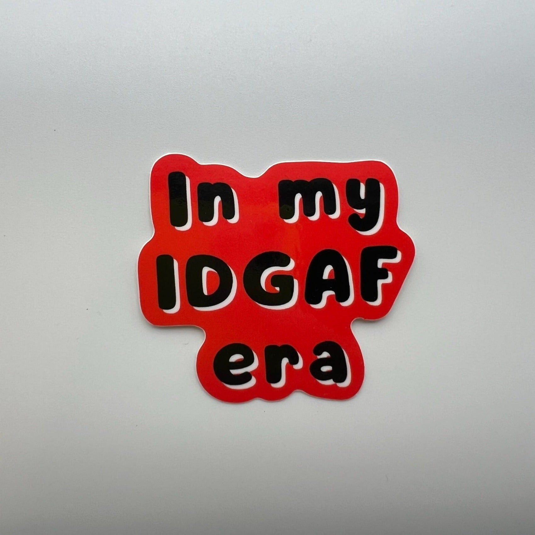 red sticker with black and white letters "In my IDGAF era"