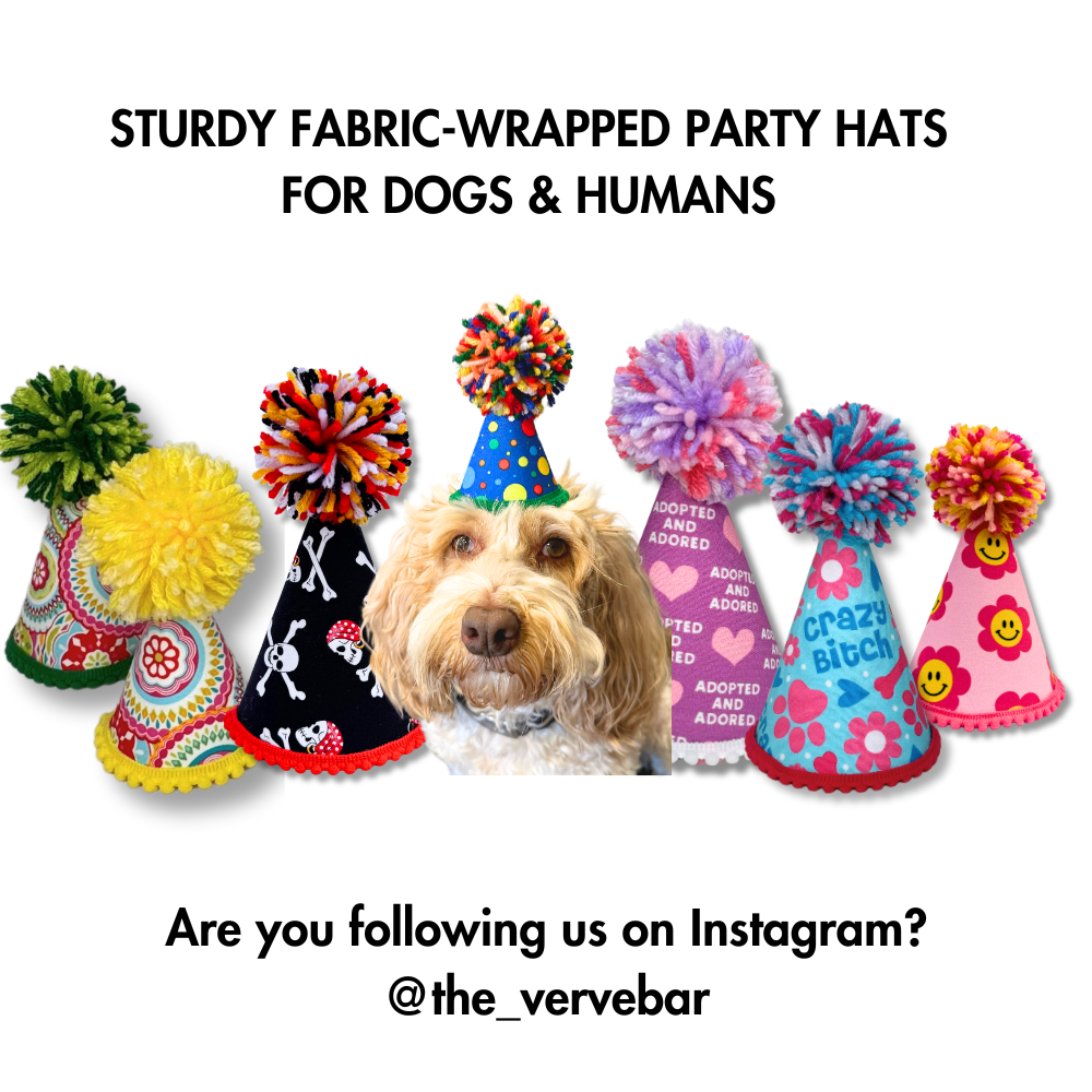 EXAMPLES OF 7 OF OUR STURDY FABRIC WRAPPED PET PARTY HATS (WORK GREAT FOR HUMAN BIRTHDAYS TOO). IN THE CENTER IS A LABRADOODLE MODELLING A SIZE SMALL PET BITHDAY HAT.