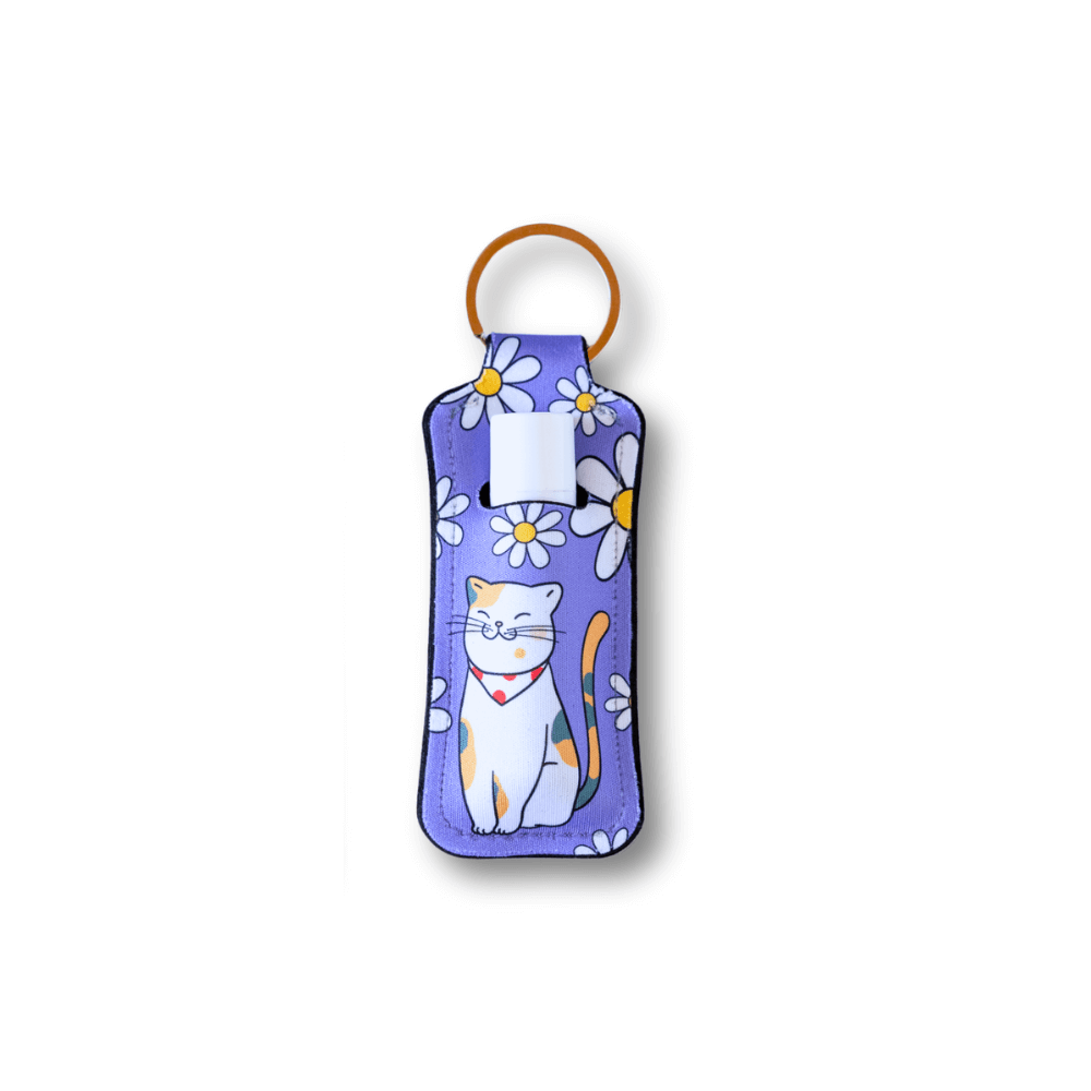 lavender background with white daisies and calico cat lip balm holder keychain