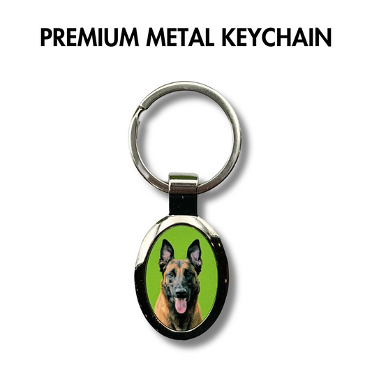 custom photo metal keychain for dog lover featuring an oval photo of a belgian malinois with a green background.