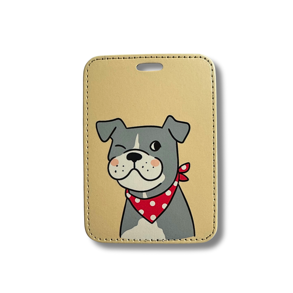 cutest pit bull luggage tag. Beige background with cartoon gray and white pit bull dog wearing a red and white bandana. The pup is smiling and winking.