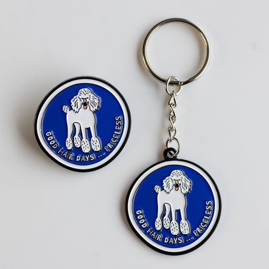 Blue and white keychain and pin with cartoon poodle: good hair days, priceless