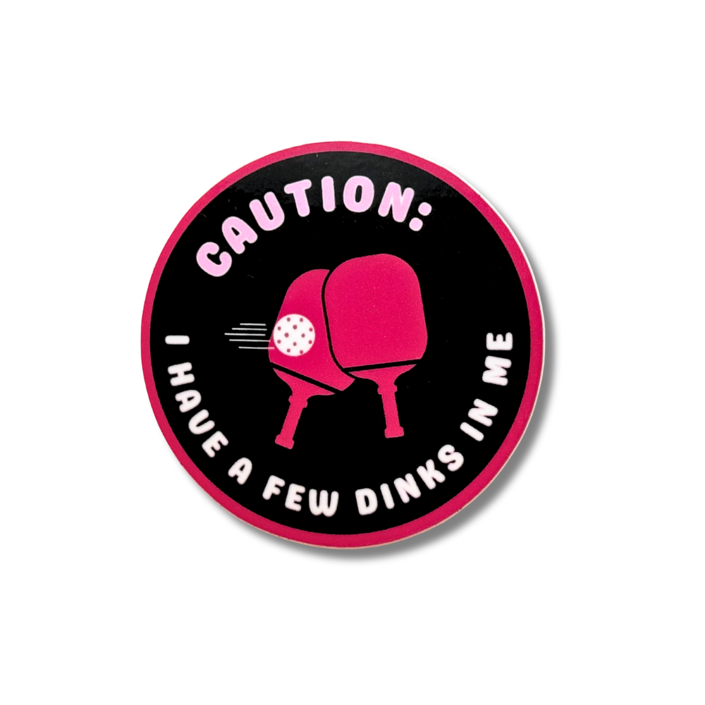 decal boozy pickleball humor: black adn hot pink sticker with two paddles in the middle "Caution, I have a few dinks in me"