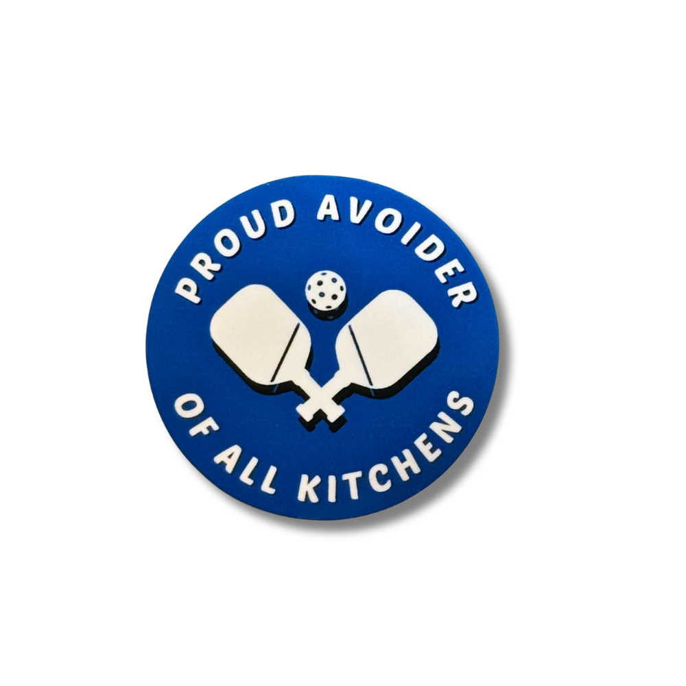 Round blue and white vinyl Pickleball sticker "Proud avoider of all kitchens" in white and white paddles and ball in center