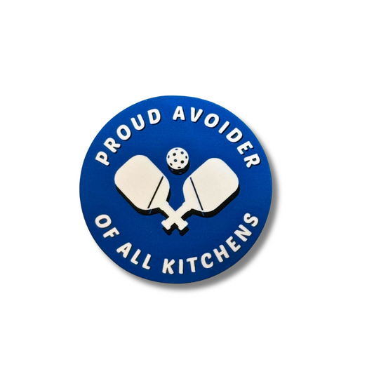 Round blue and white vinyl Pickleball sticker "Proud avoider of all kitchens" in white and white paddles and ball in center