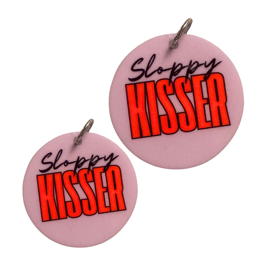 Cute dog accessory for valentines. Lavender circle with black script font "Sloppy" and tall modern font "Kisser." shown in two sizes for standard size breeds and large / XL breeds