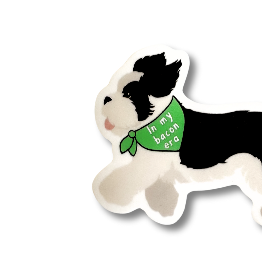 Close up of bandana that the sheepadoodle dog is wearing. Black and white sticker (green bandana)