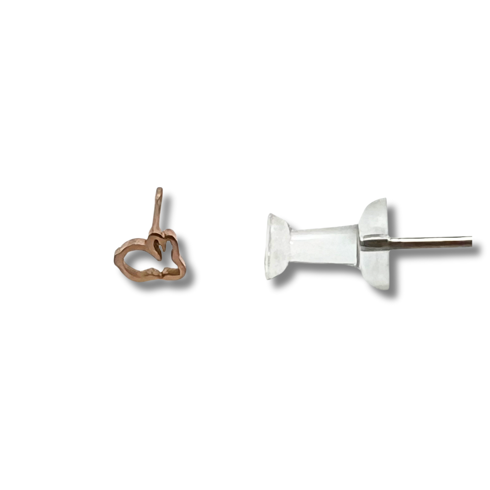 bunny earring compared to a push pin for size