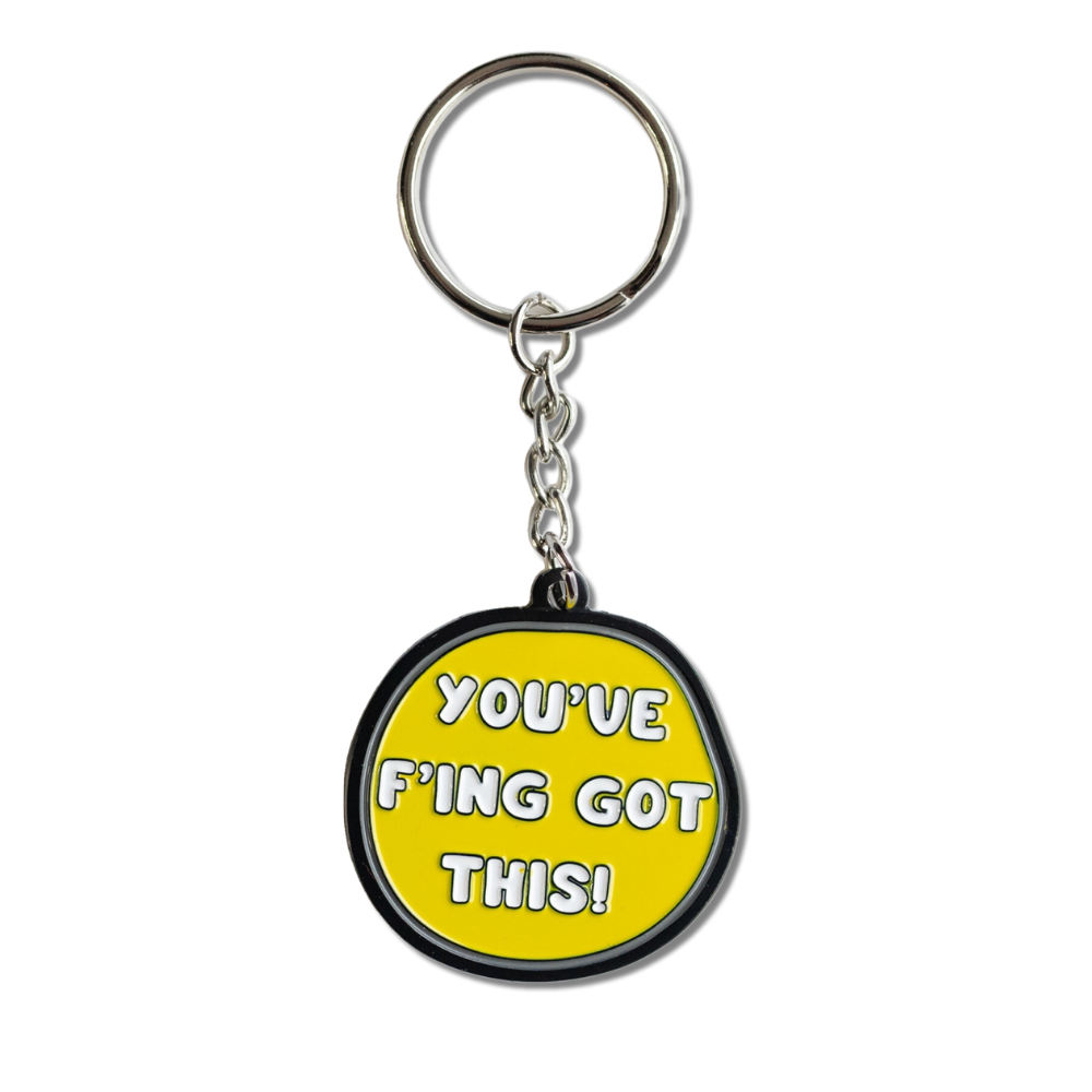 FULL VIEW - yellow round-ish enamel keychain with gray and black border and white text: You've f'ing got this!.