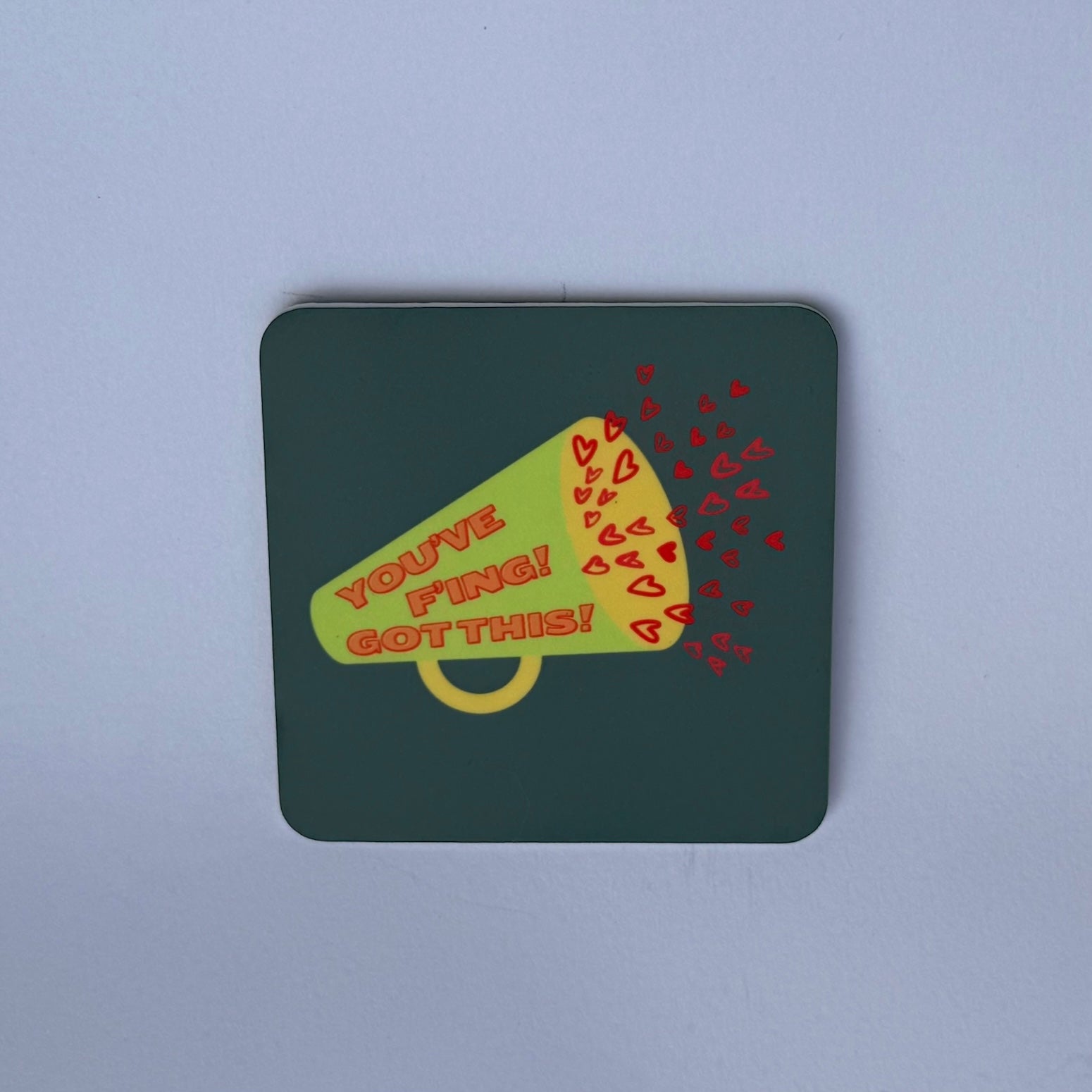 grey magnet with cartoon green and yellow megaphone. Red cartoon hearts coming out of the megaphone. Word: You've F'ing got this!