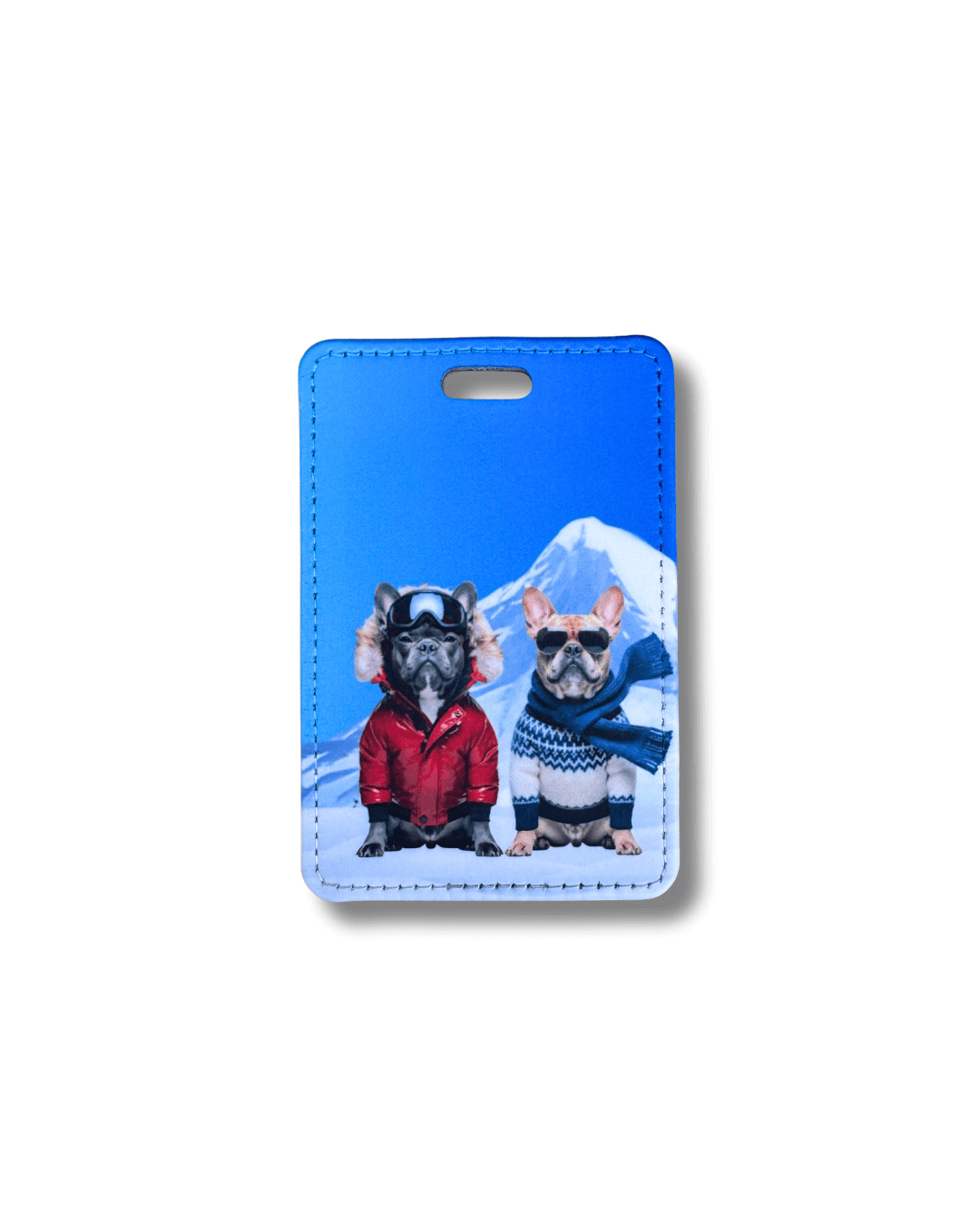 Luggage tag featuring two French Bulldogs in winter ski attire and a mountain / blue background