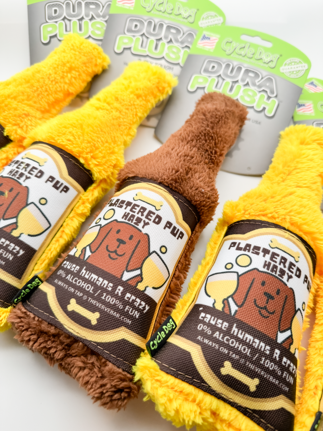 close up of brown and yellow Plastered Pup Hazy beer bottle dog toys