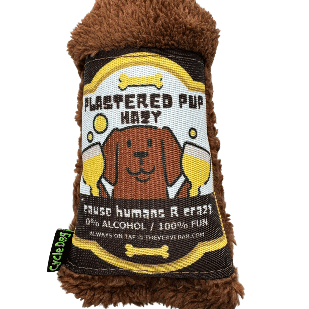 close up of dog beer toy label with dog holding two beers "Plastered Pup Hazy, 'cause humans are crazy"