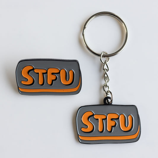 Charcoal gray and orange enamel keychain and pin: STFU