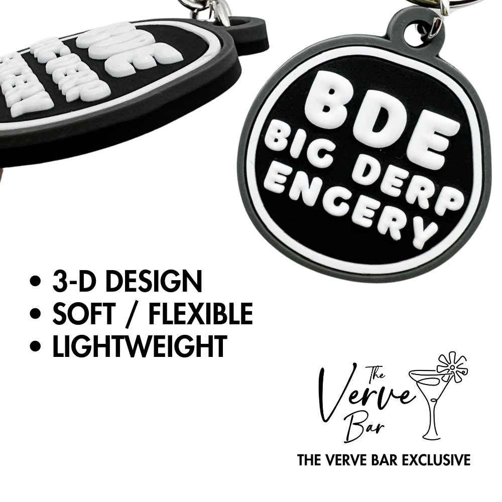 close up showing raised 3-D design on funny Keychain  for nerdy friend "BDE, Big Derp Energy"- black, gray, and white irregular circle.