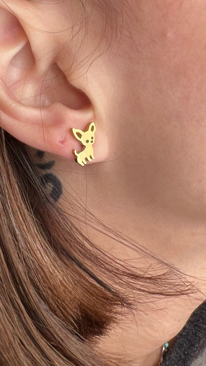 close up of gold chihuahua earring in ear to show size