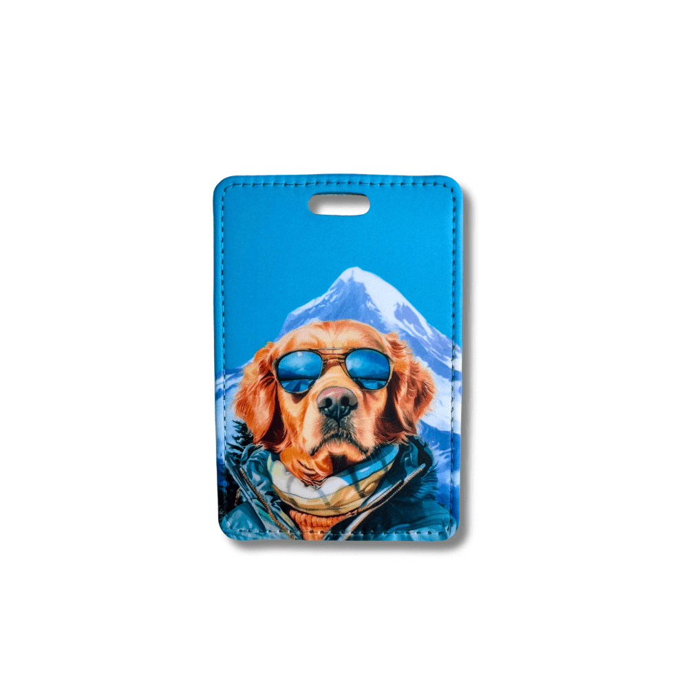 golden retriever luggage tags with a sunglasses in front of a mountain. Blue sky background.