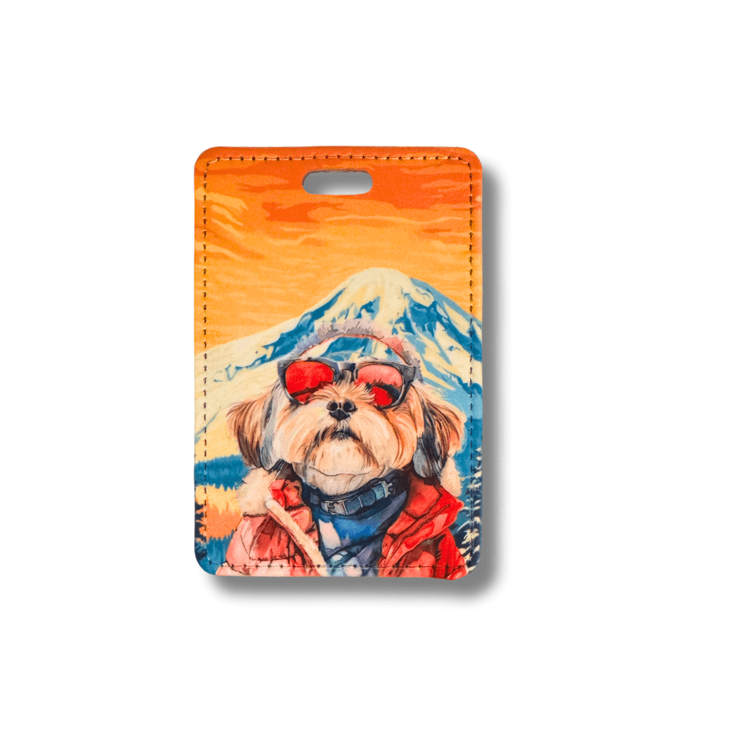 Havanese dog in ski goggles and red parka against mountain background on faux leather luggage tag.