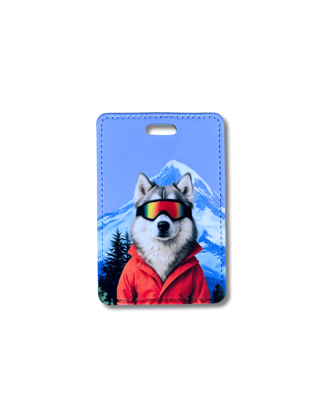 husky ski luggage tag; husky wearing ski goggles and orange jacket with snowy mountain background on blue travel tag