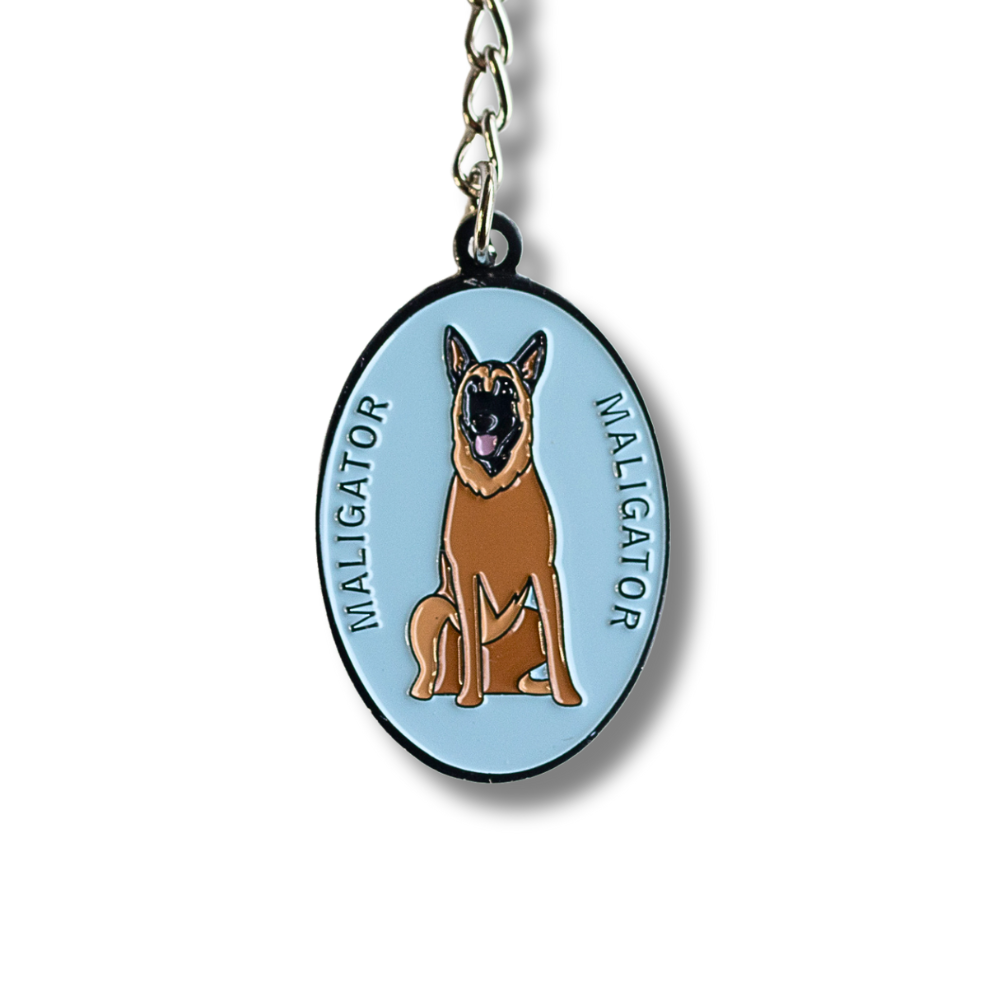 close up of oval light blue enamel keychain; Belgian Malinois dog and text that says Maligator on each side of the dog