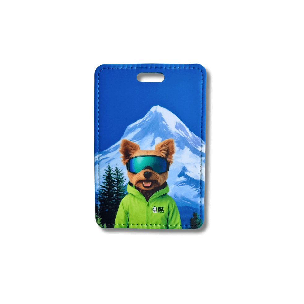 Yorkie ski luggage tag with mountain background featuring Yorkie in ski jacket and goggles.