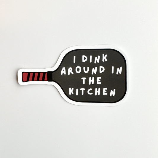 Pickleball humor sticker: pickleball paddle with text "I dink around in the kitchen"