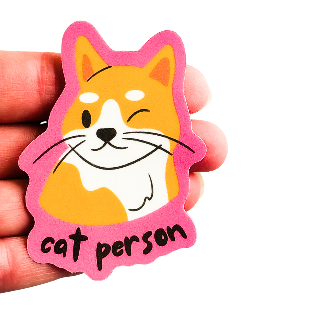 size comparison of cat person sticker against 4 fingers