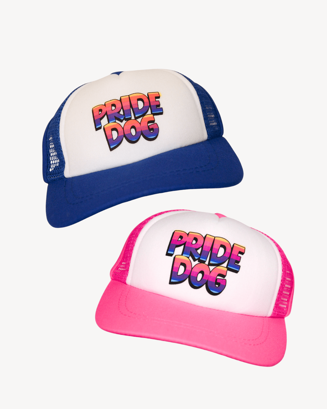 Two pride dog trucker hats, one blue and one pink with rainbow font "Pride Dog"