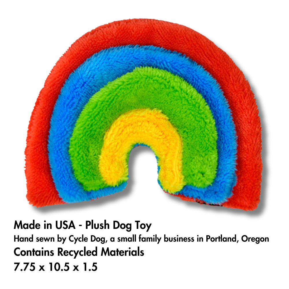 4 layer unstuffed plush rainbow pride dog toy (red, blue, green, yellow) with info at bottom about Made in USA, size, and eco-friendly