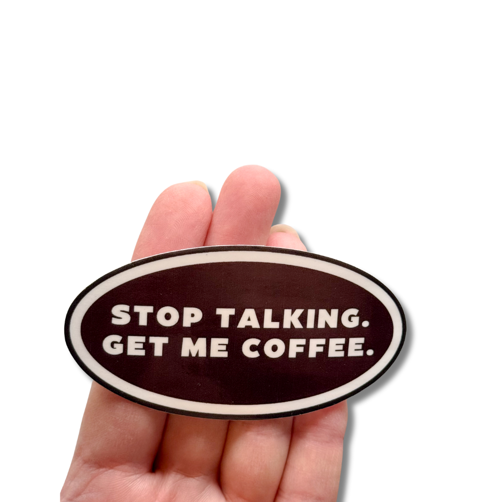 photo of the coffee sticker against 4 fingers to show size comparison. This sticker is 3.5" wide and goes past the fingers of a ladies hand on both sides.