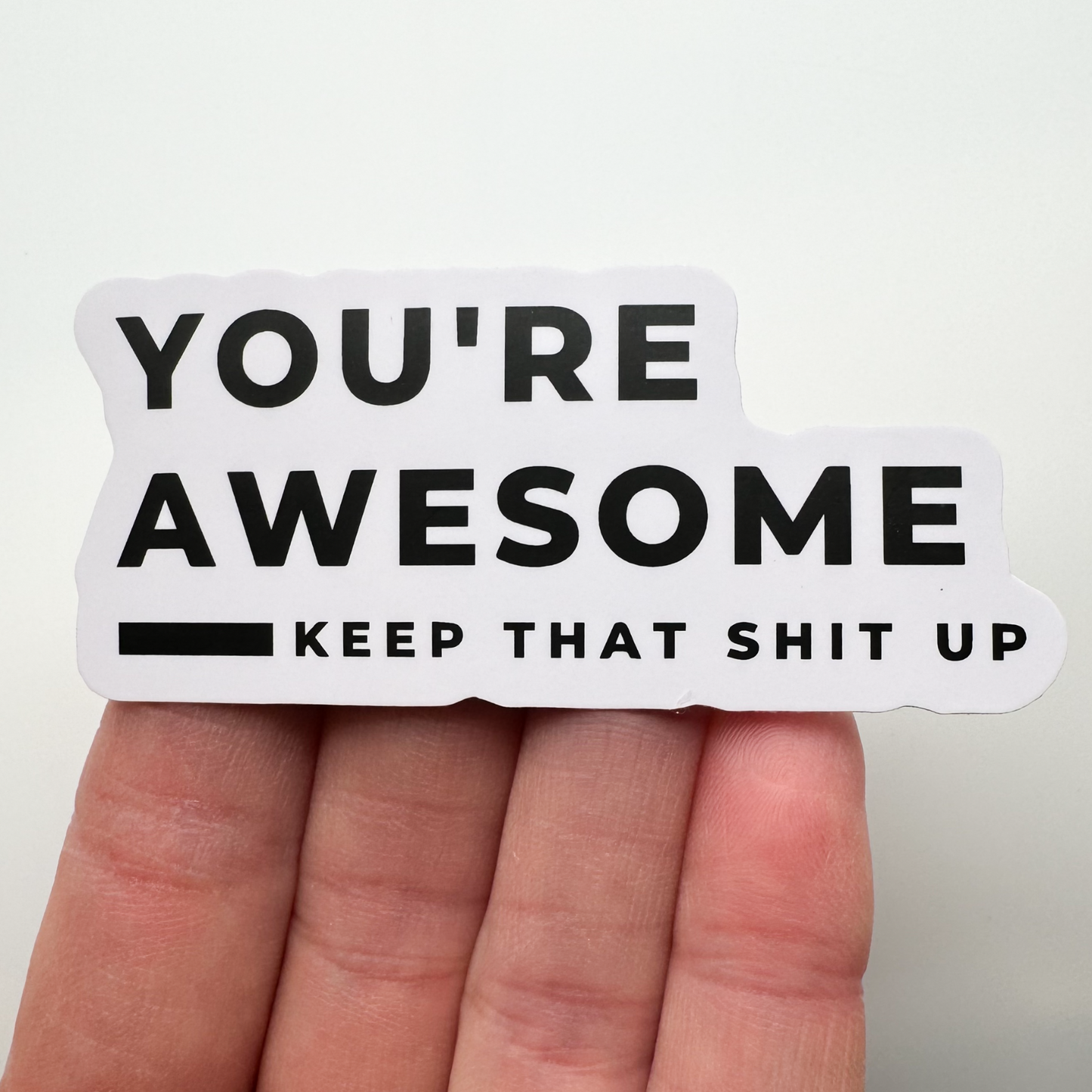 You're awesome sticker shown against fingers for scale (it's wider than 4 fingers)